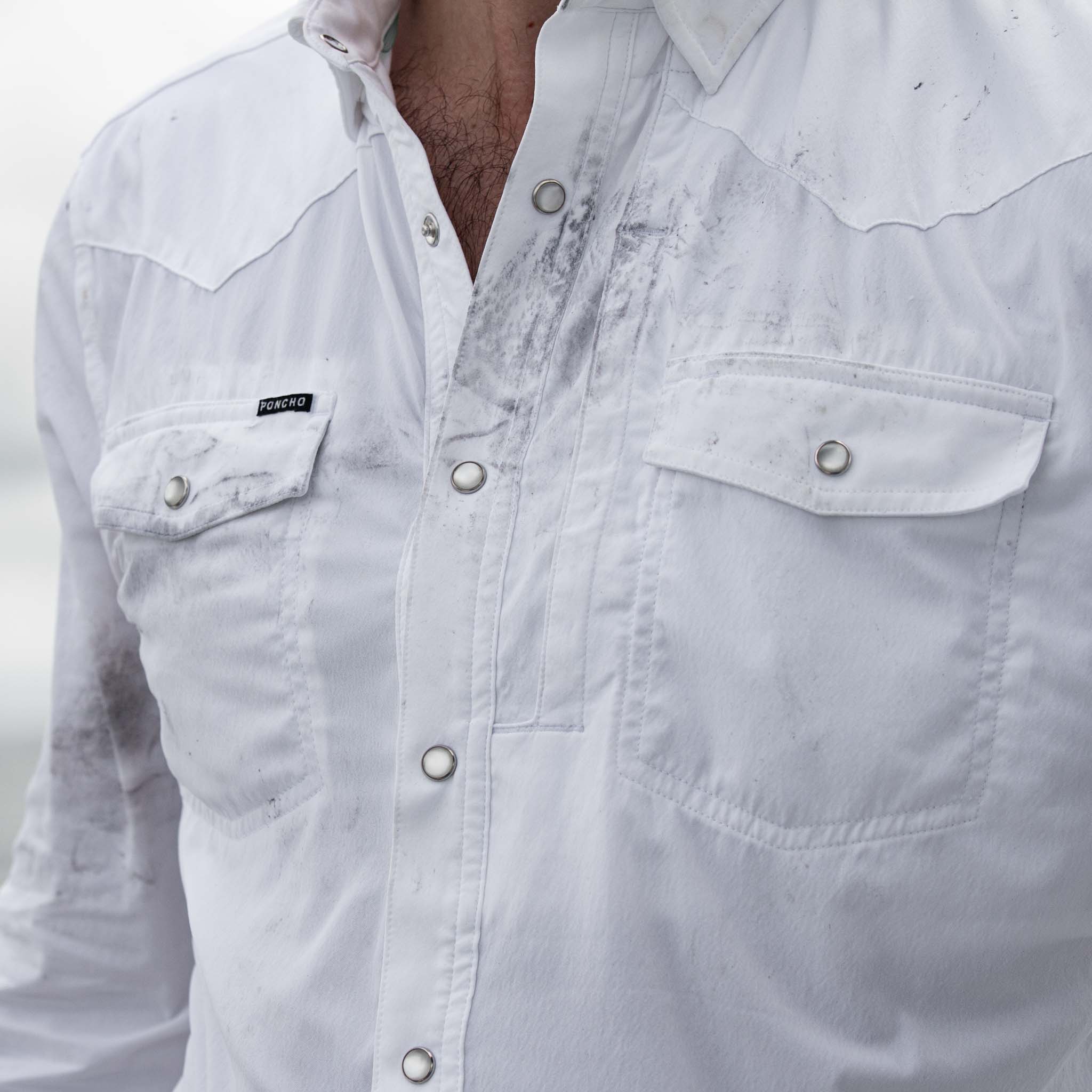Close up of fabric of long sleeve white shirt