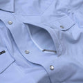 Close up photo of the chest zipper pocket of the blue microcheck shirt