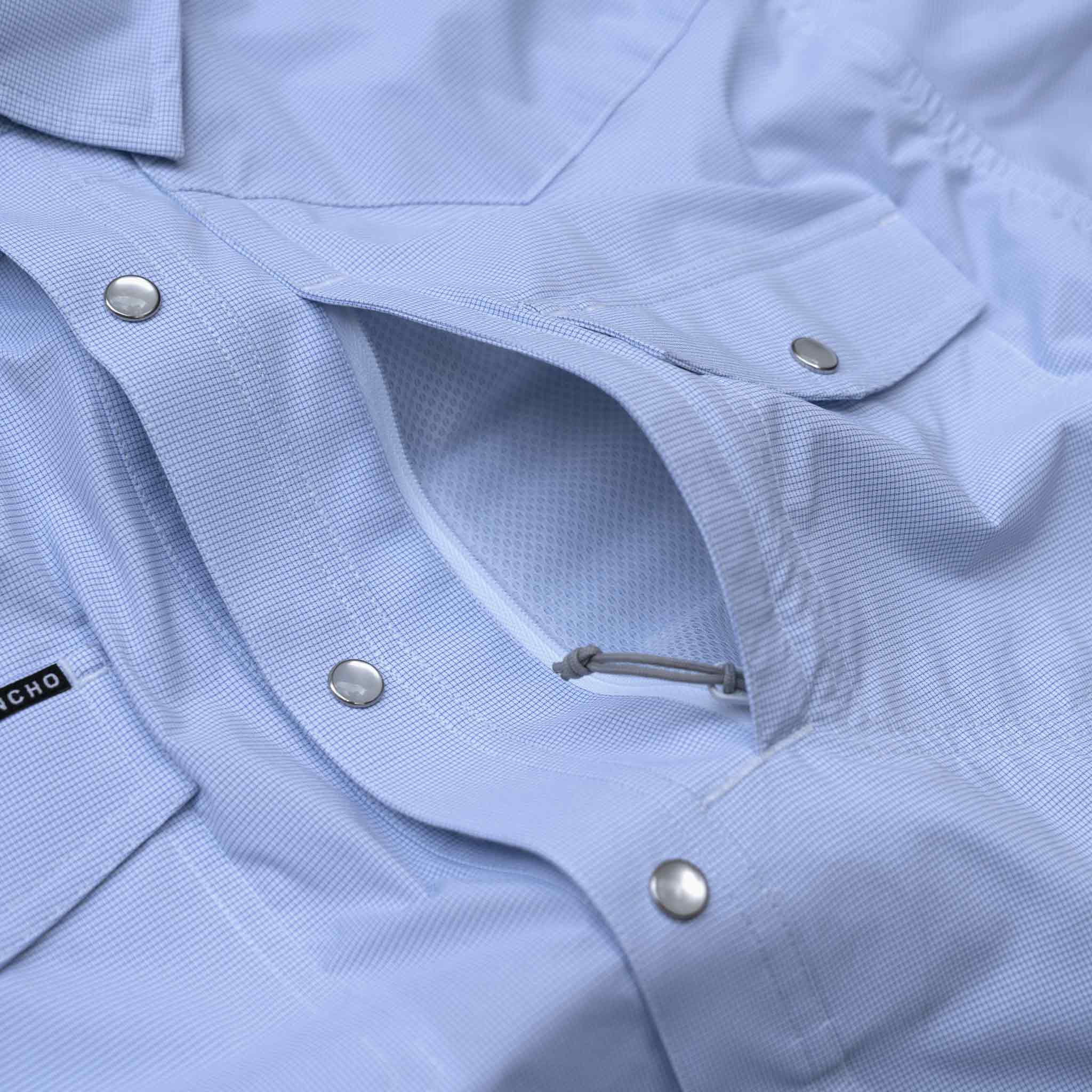 Close up image of the chest pocket on the blue microcheck western zipper pocket
