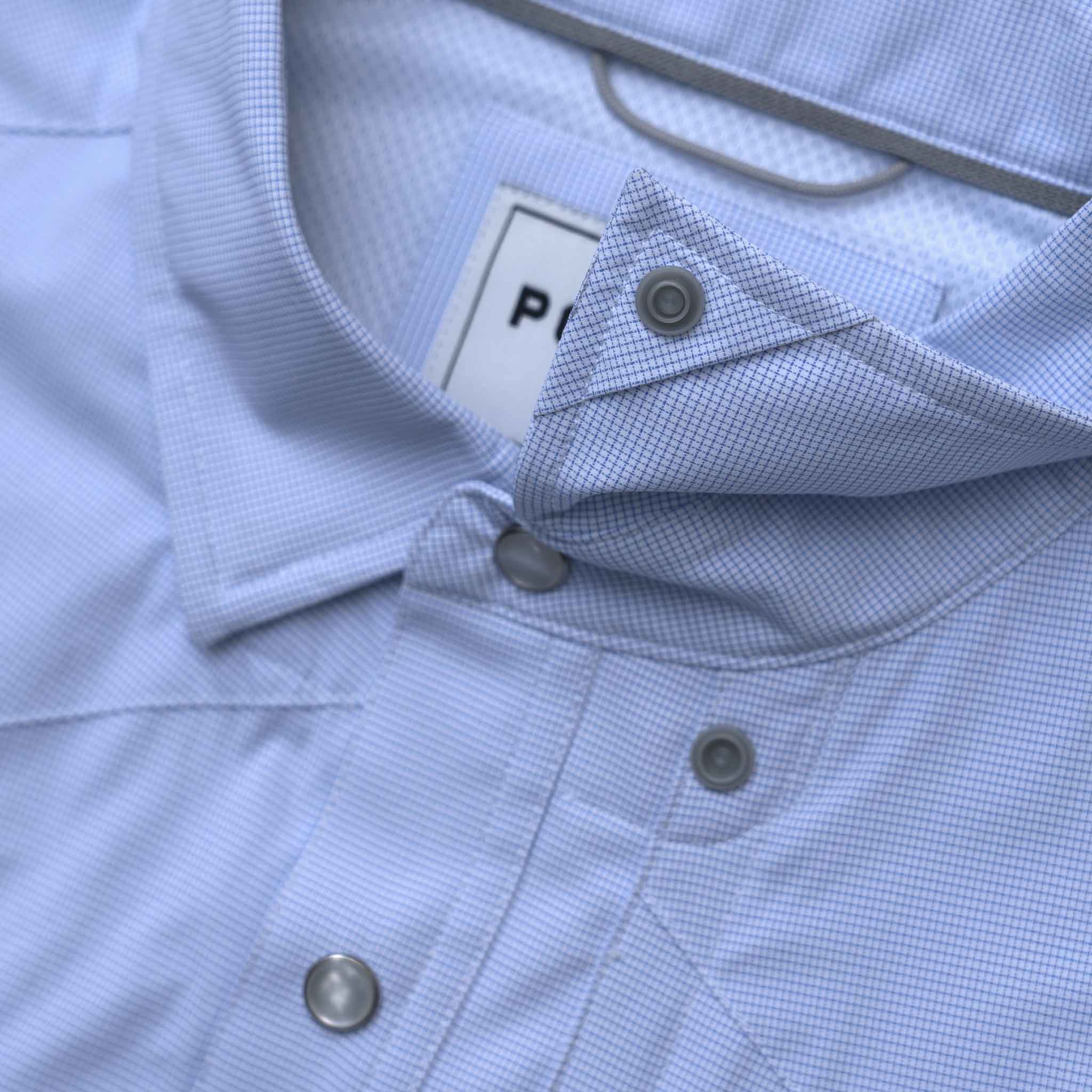 Close up image of the collar snaps on the blue microcheck shirt