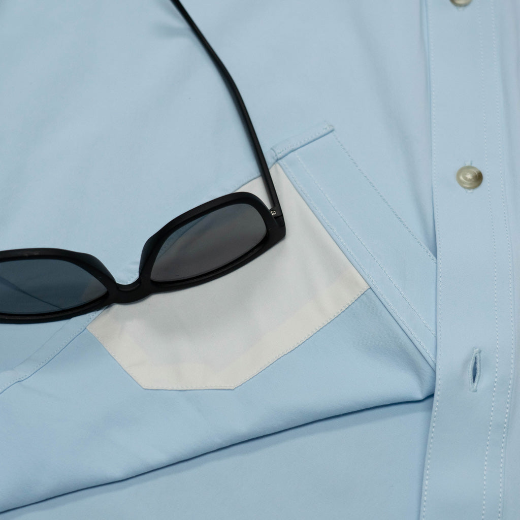 Close up of sunglasses on top of shirt