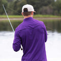 Man wearing short sleeve purple pearl snap shirt fishing