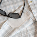 Close up photo of sunglasses and shirt 