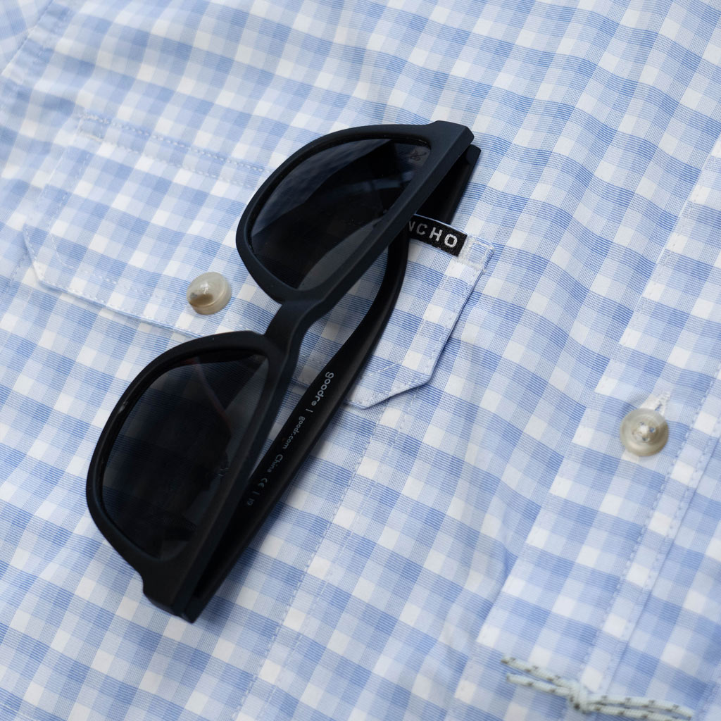 blue plaid shirt close up with sunglasses